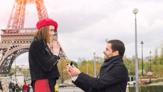 someone proposing in front of eiffel tower with an engagement ring