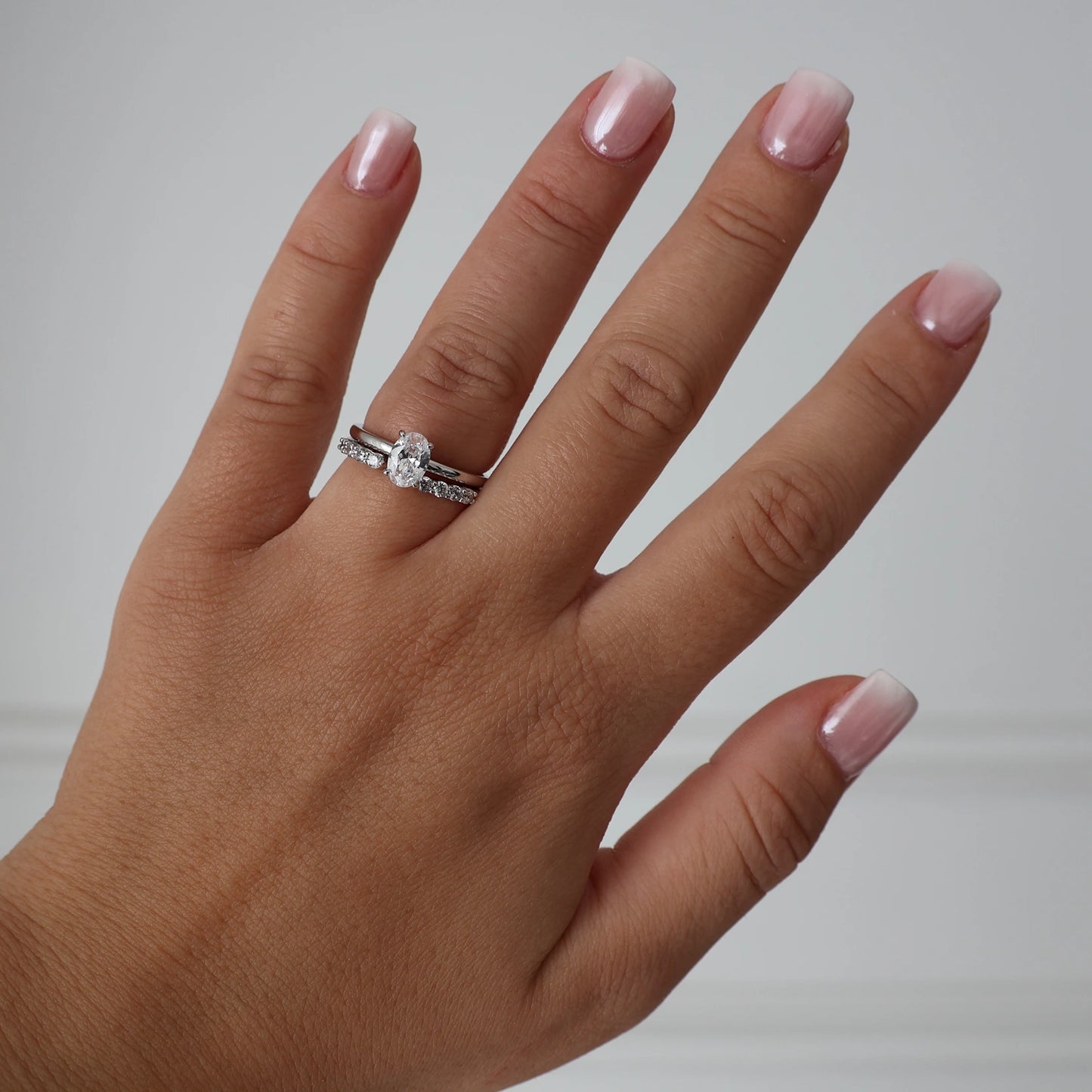 1 carat oval cut cubic zirconia ring stacked with a silver open band