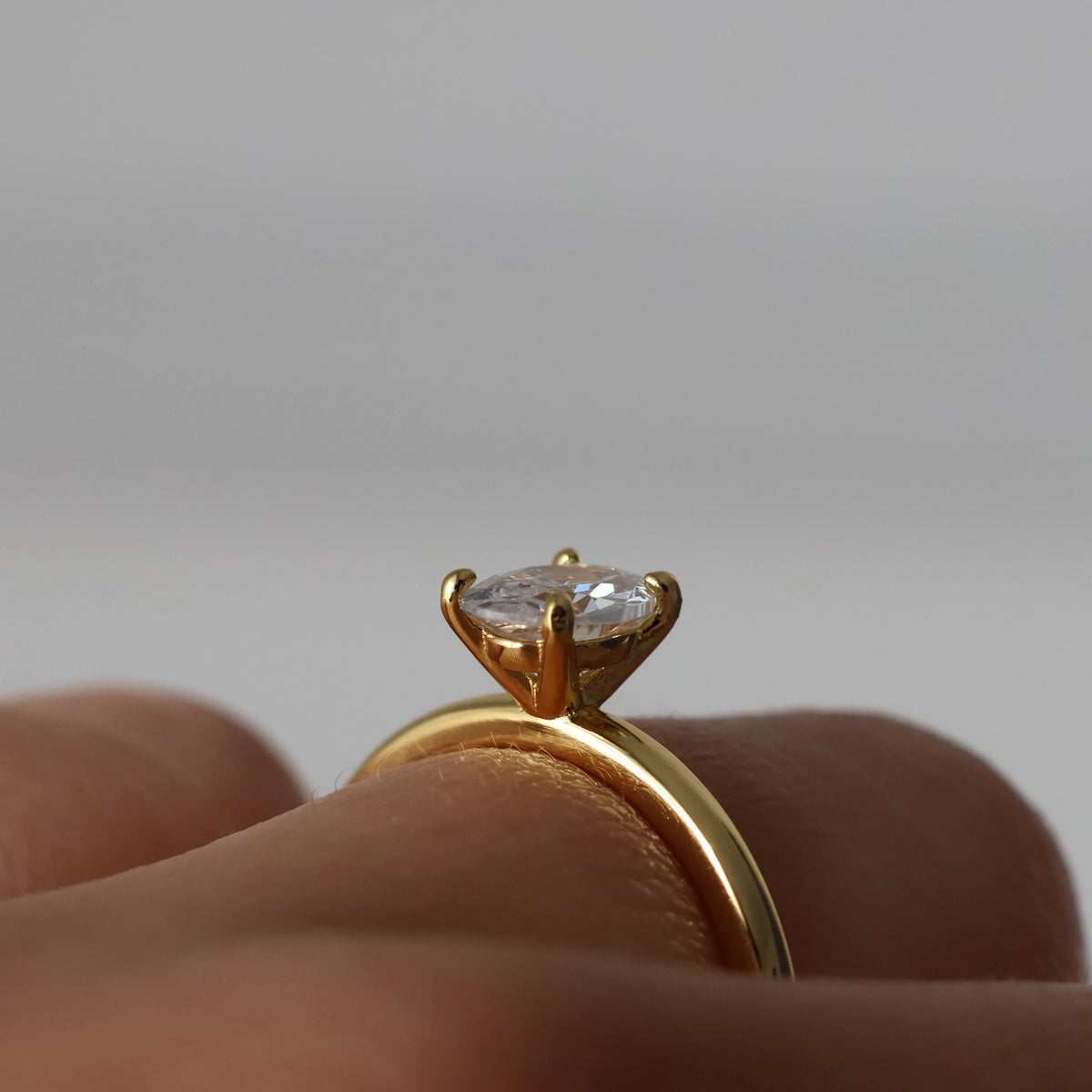 Side view of 1 ct oval solitaire CZ ring in 18k gold plated