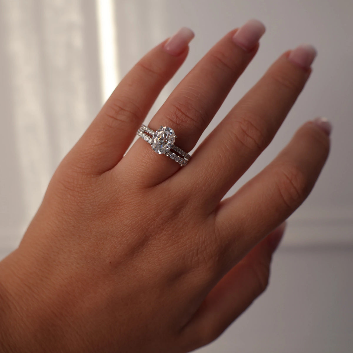 2 carat oval moissanite ring with hidden halo and pave band