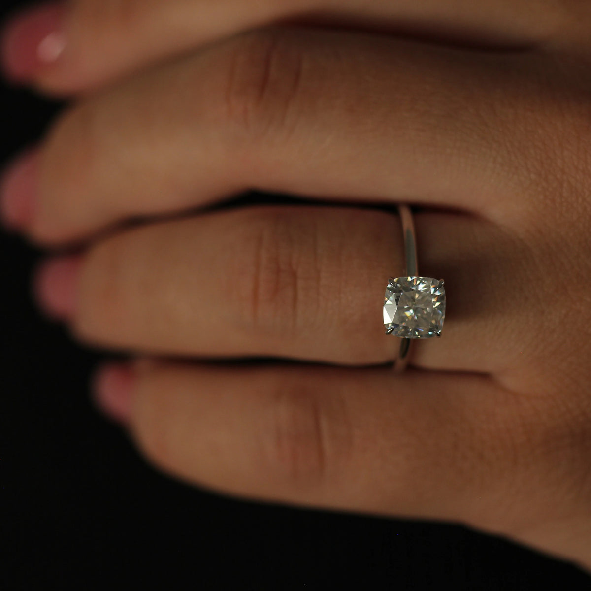 2ct cushion moissanite solitaire ring on hand