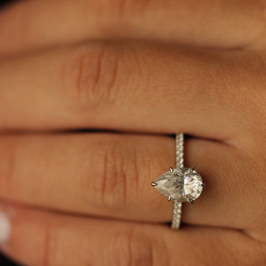 2 carat pear moissanite engagement ring on hand