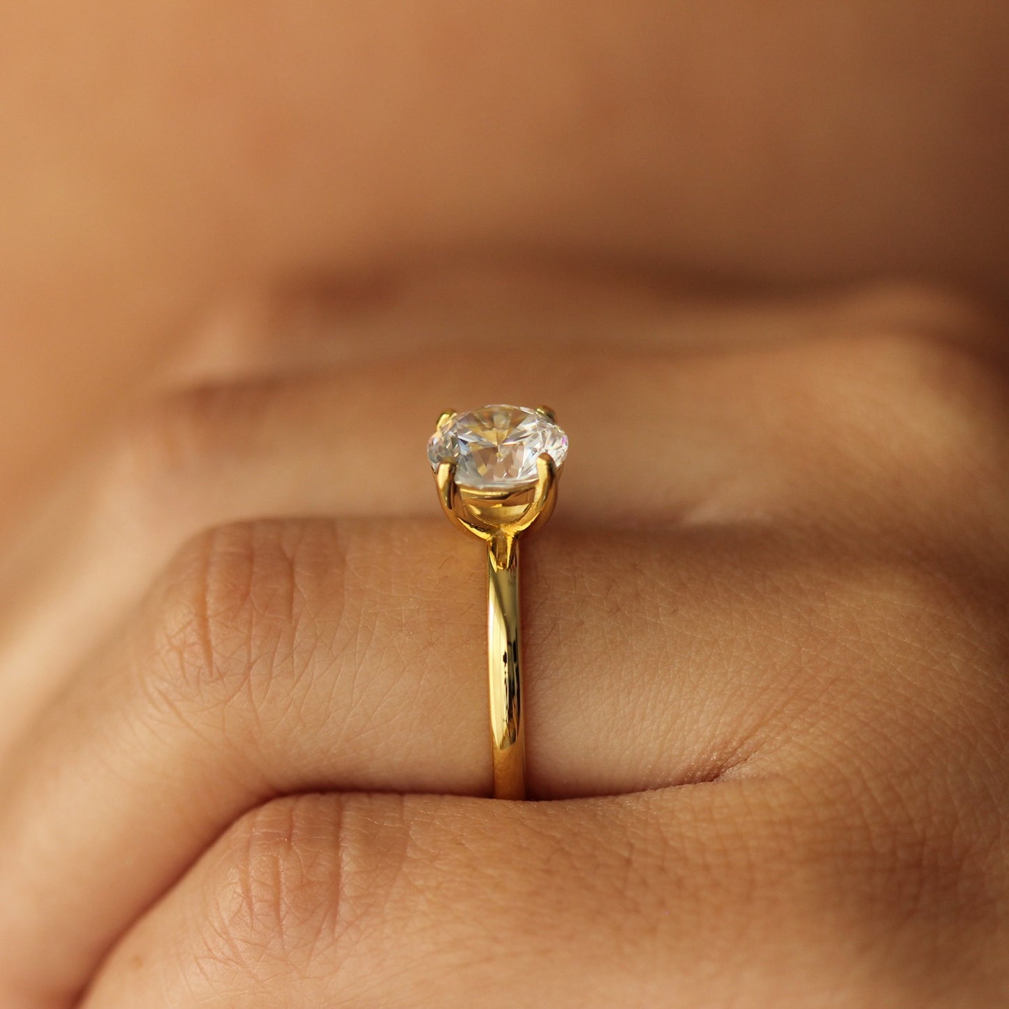 2 ct round gold engagement ring on hand side view