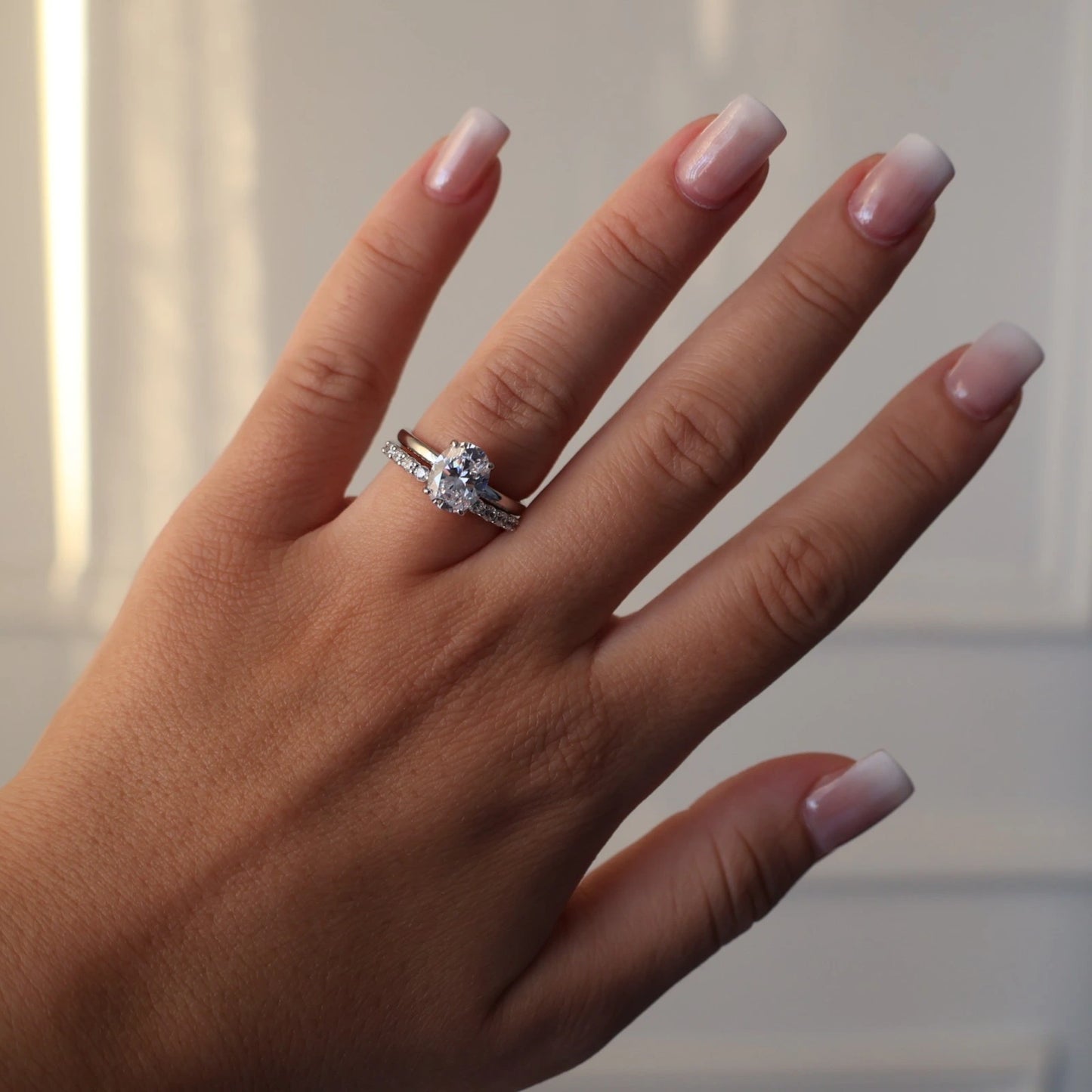 2 carat oval cut silver ring stacked with an eternity ring