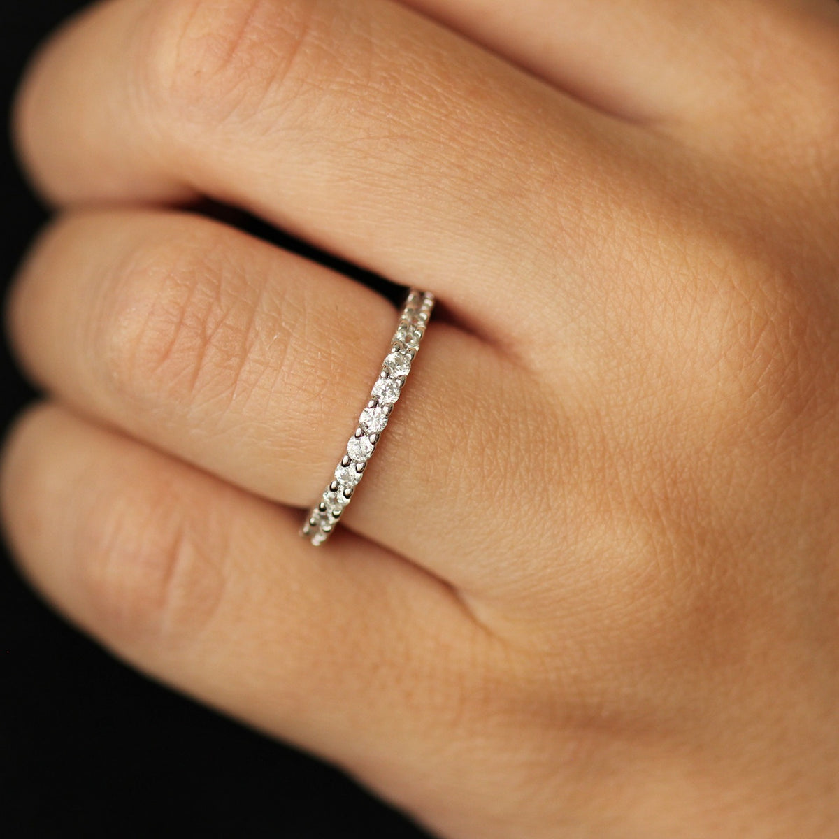 Silver eternity band on hand