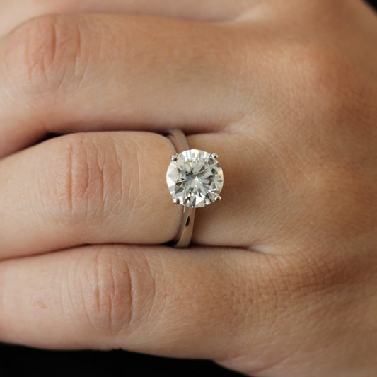 Close up of a 3 carat round moissanite solitaire ring