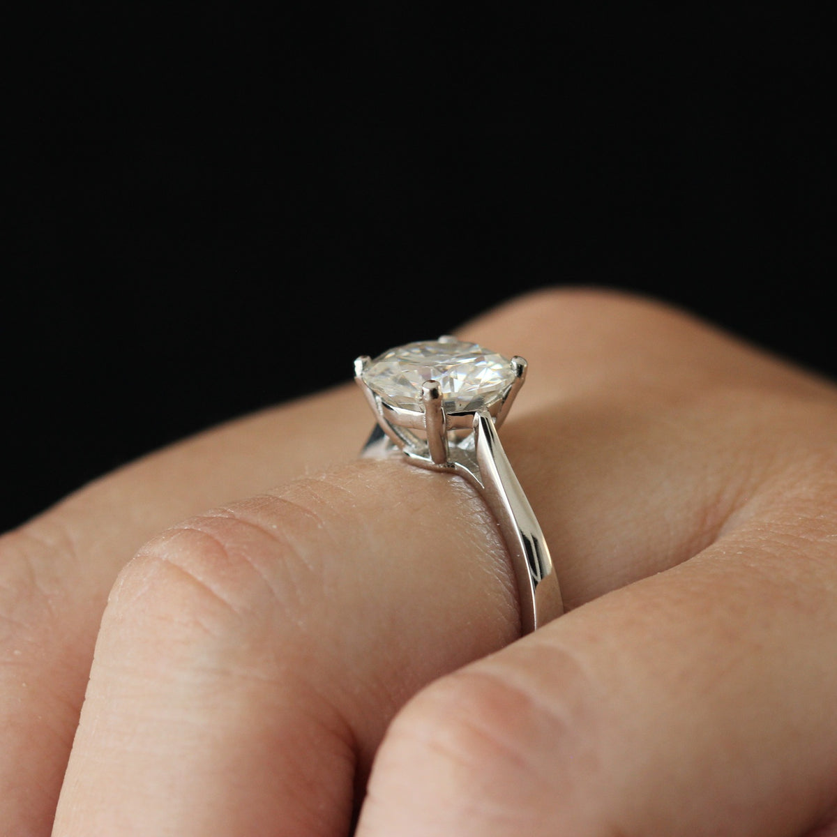 Side view of a 3 carat round moissanite solitaire ring