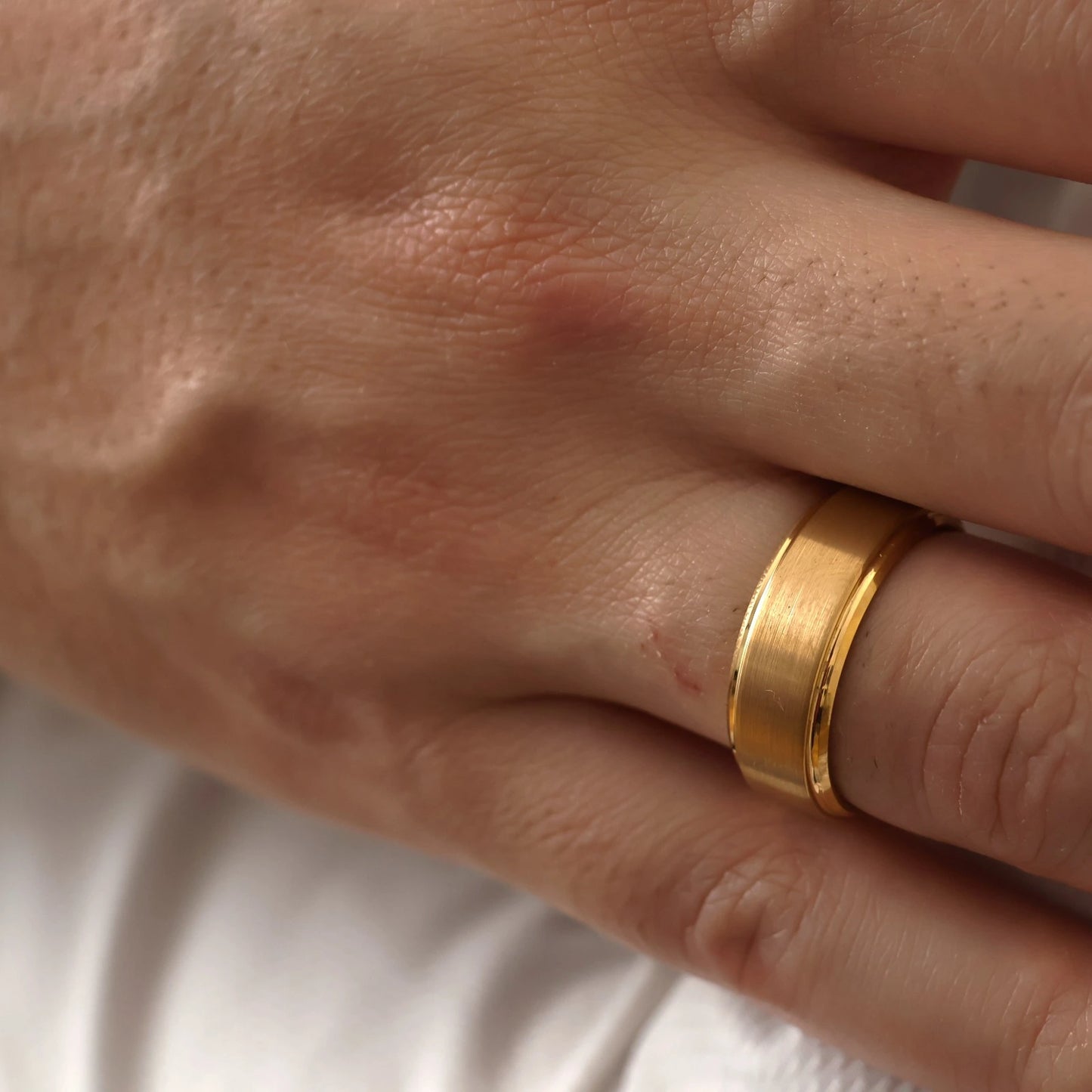 8mm tungsten wedding band with a brushed gold finish