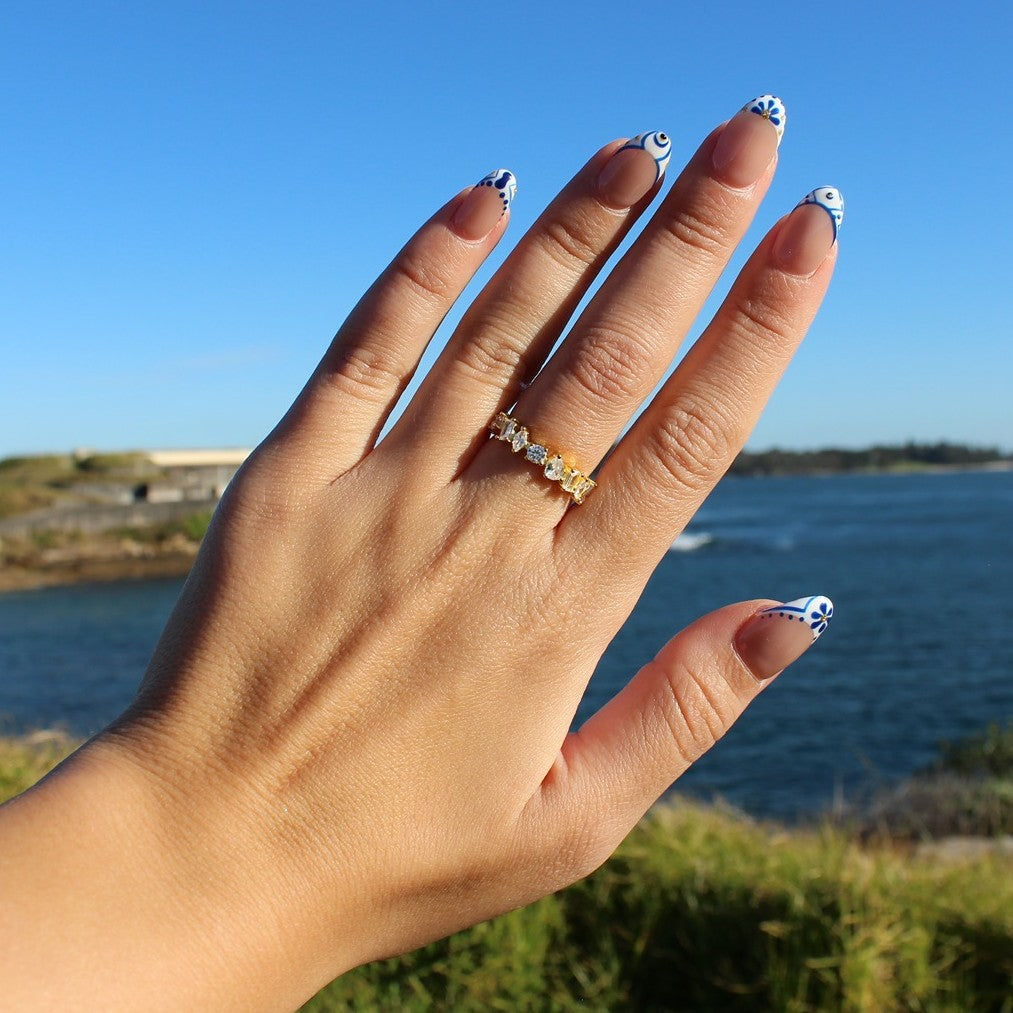 Alexandria statement ring in gold on hand at La Perouse Beach, Sydney