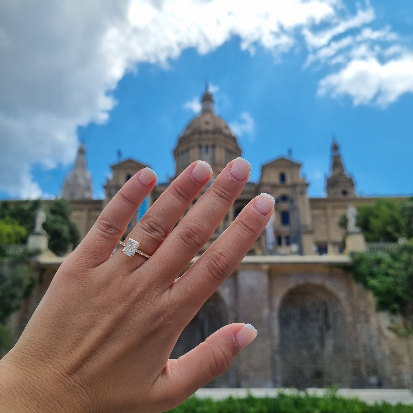 Gold radiant cut rectangle ring on hand in Barcelona