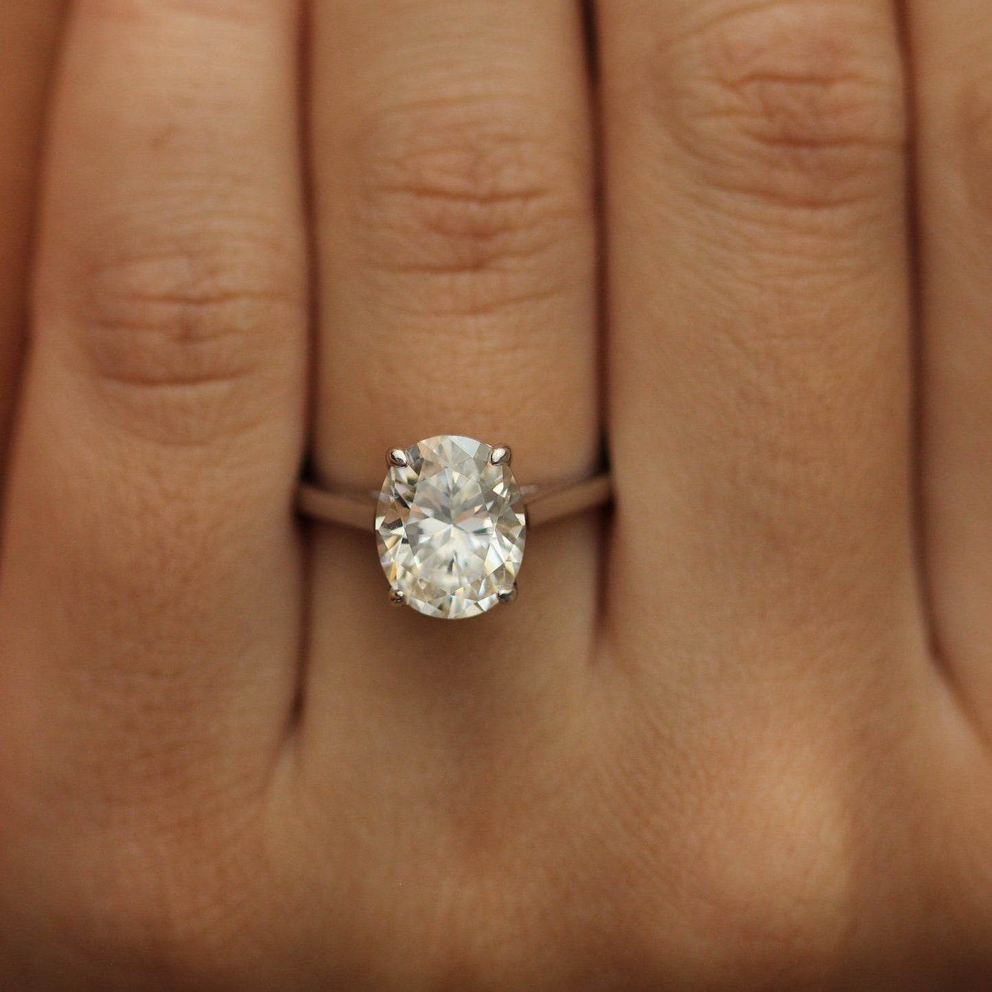 Silver cubic zirconia oval ring on hand