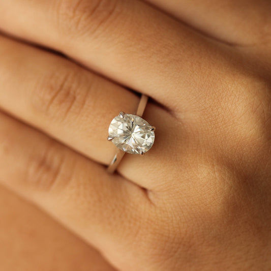 3 carat oval moissanite ring on silver band on hand