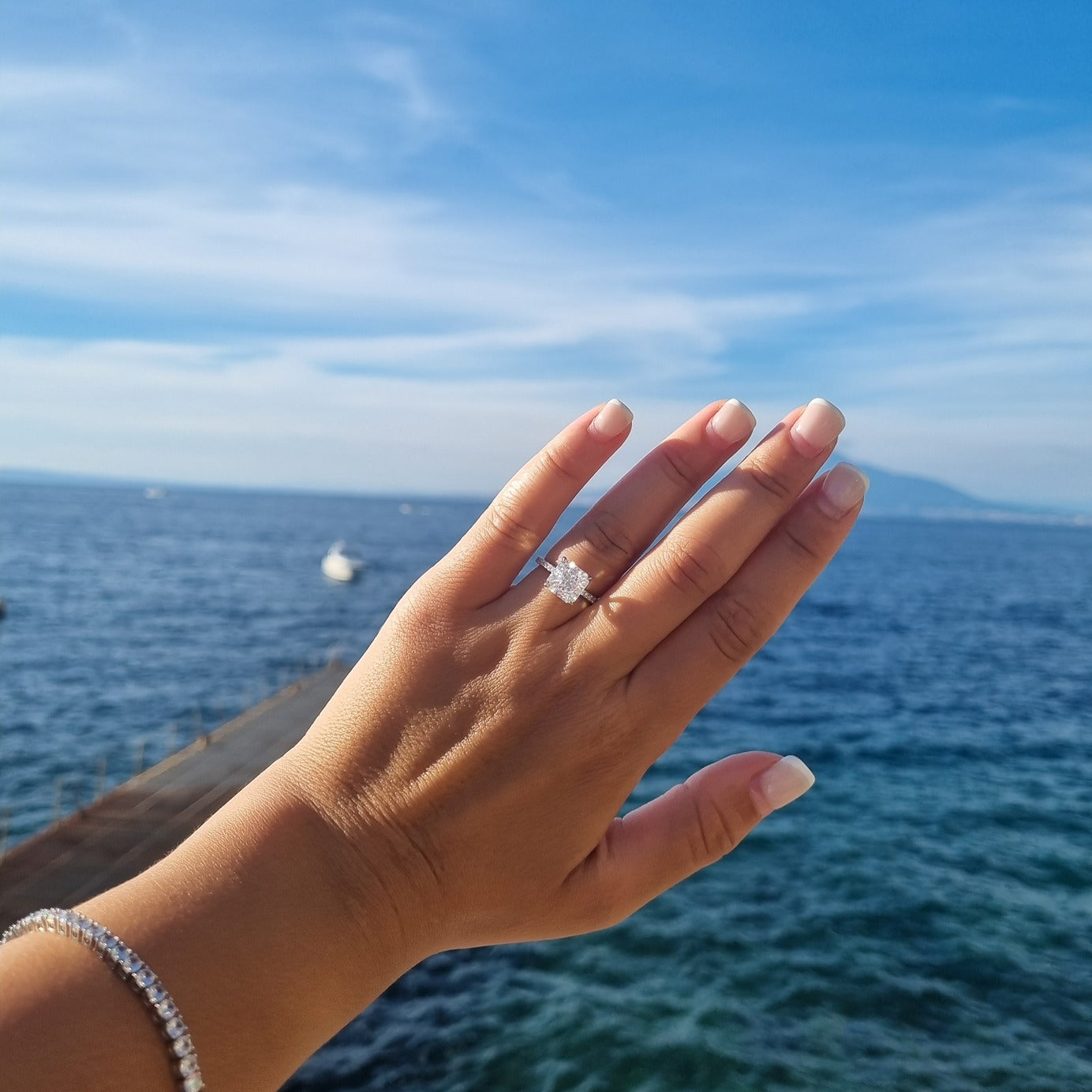 Silver radiant cut ring on hand in Positano, Amalfi Coast