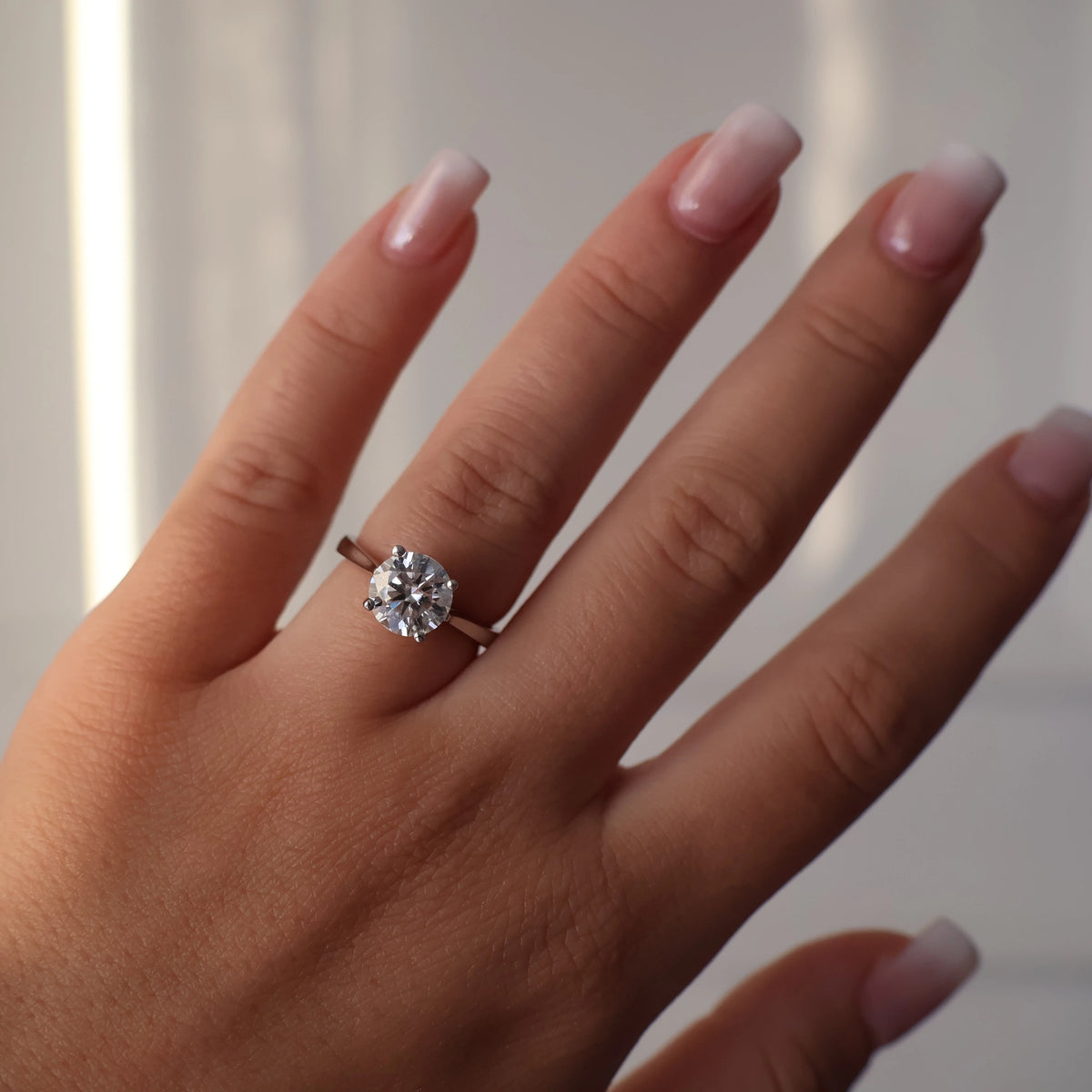 2ct round moissanite ring on hand