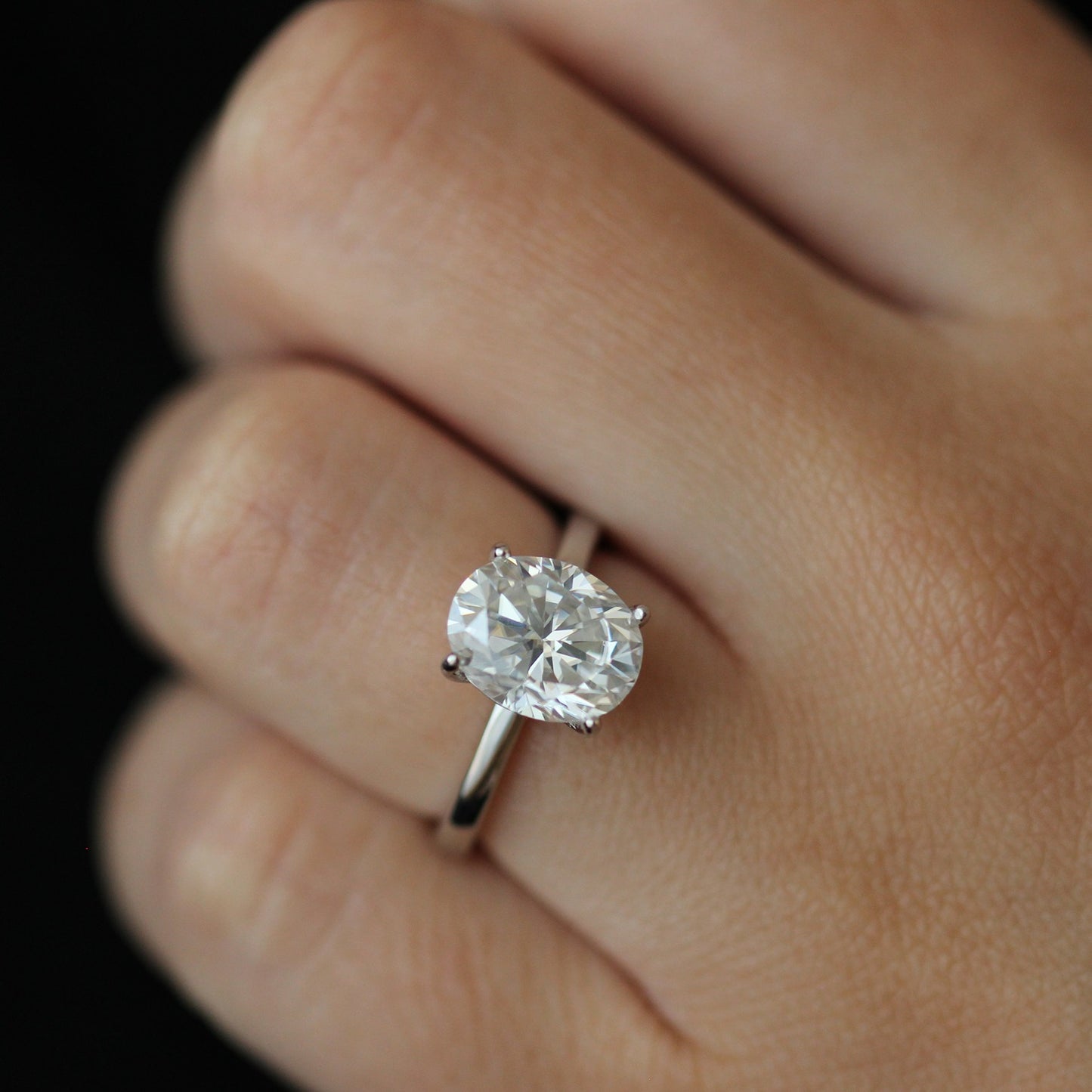 Front view of 3ct oval moissanite ring on hand