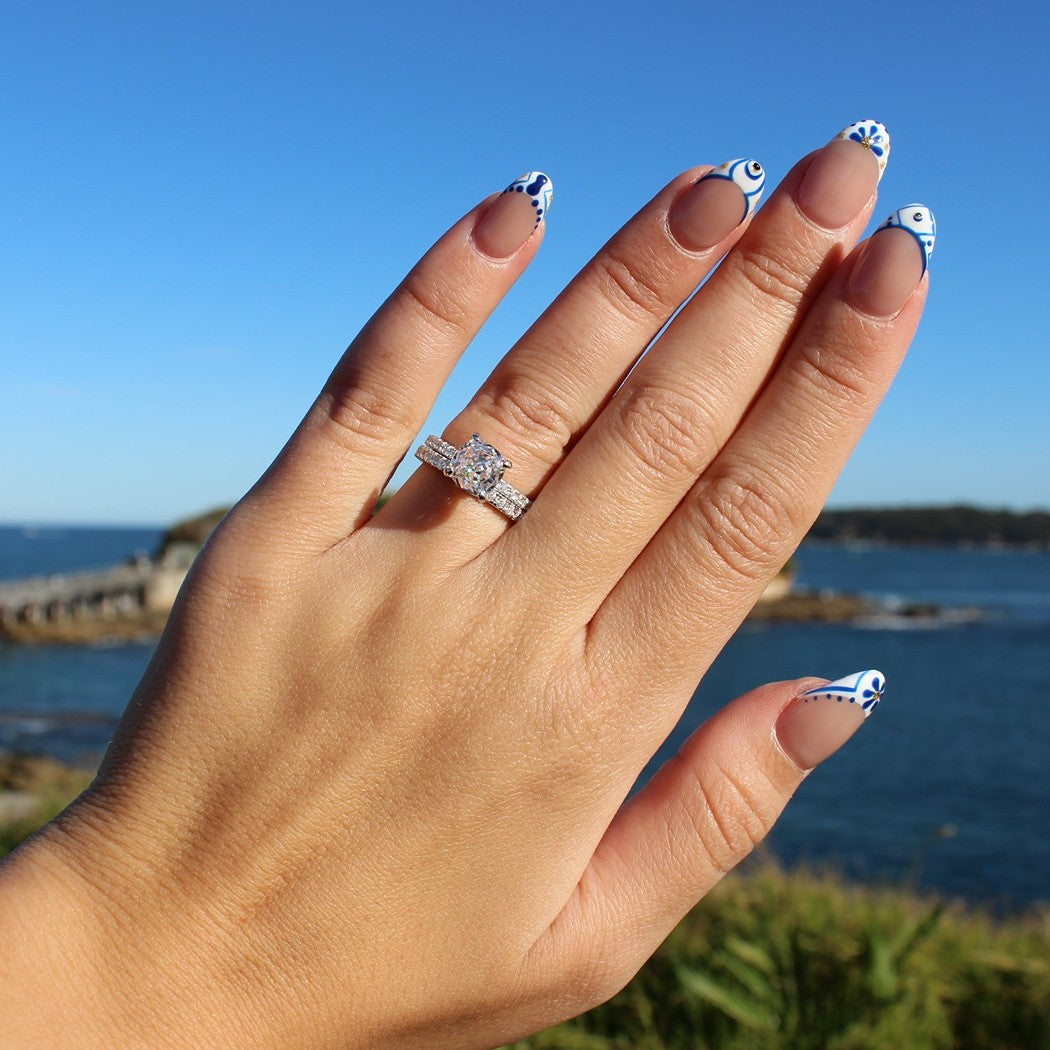 Pave eternity ring and round cut ring on hand at La Perouse Beach, Sydney