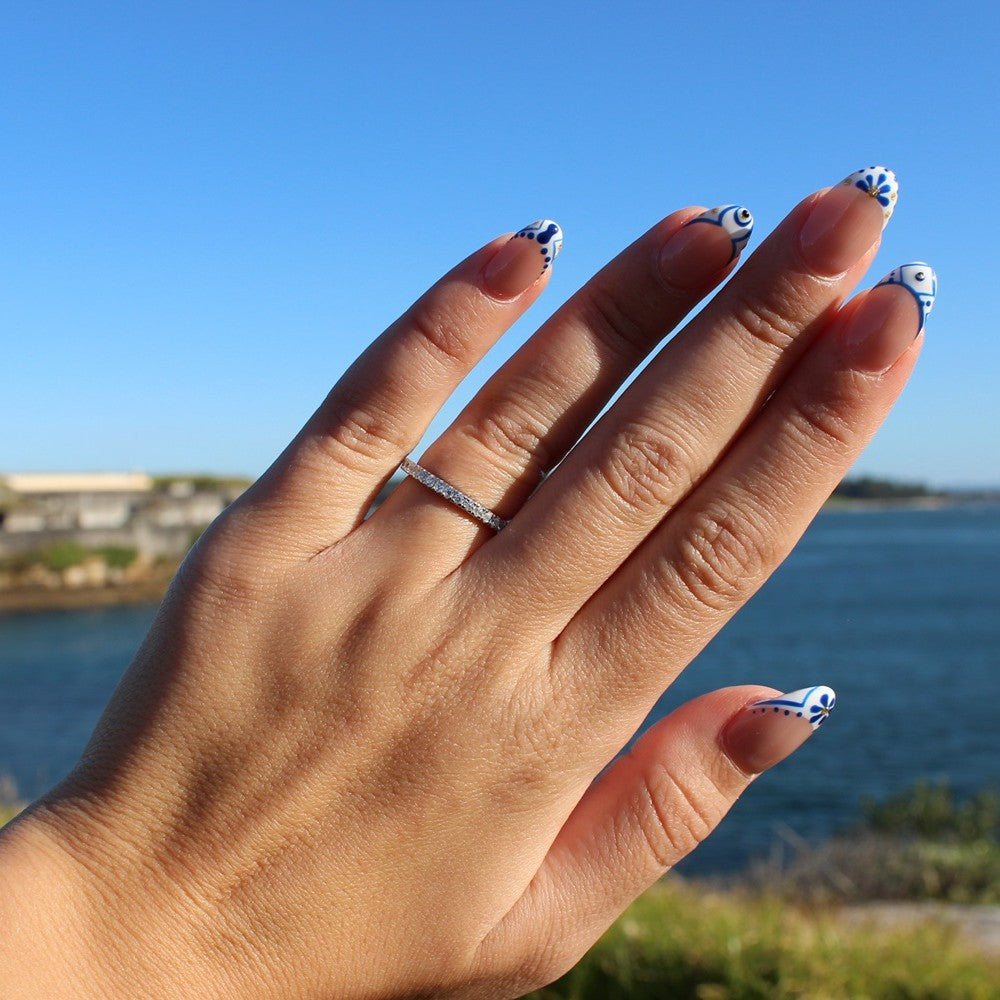 Pave eternity ring on hand at La Perouse Beach, Sydney
