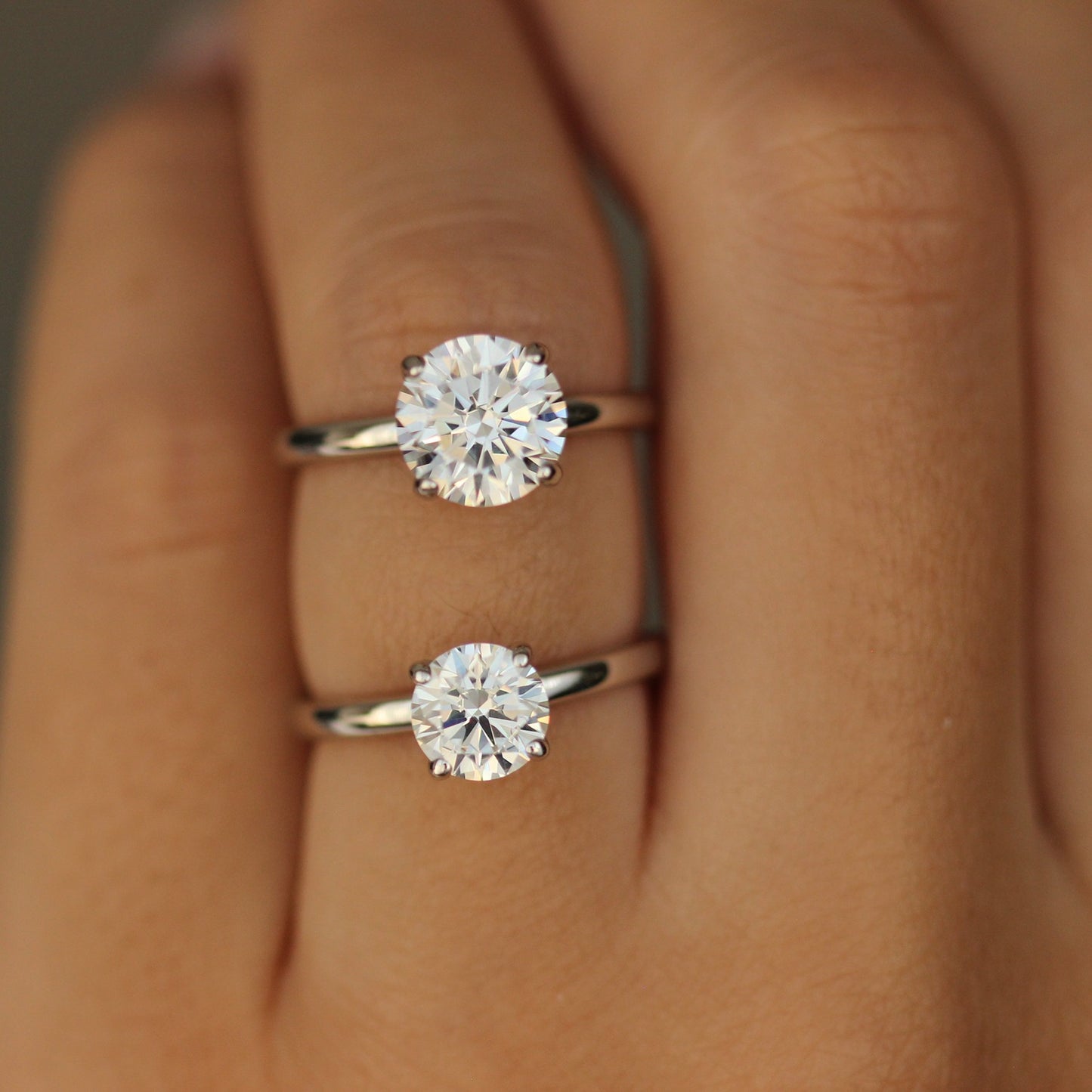 1ct Round ring and 2ct round ring on hand