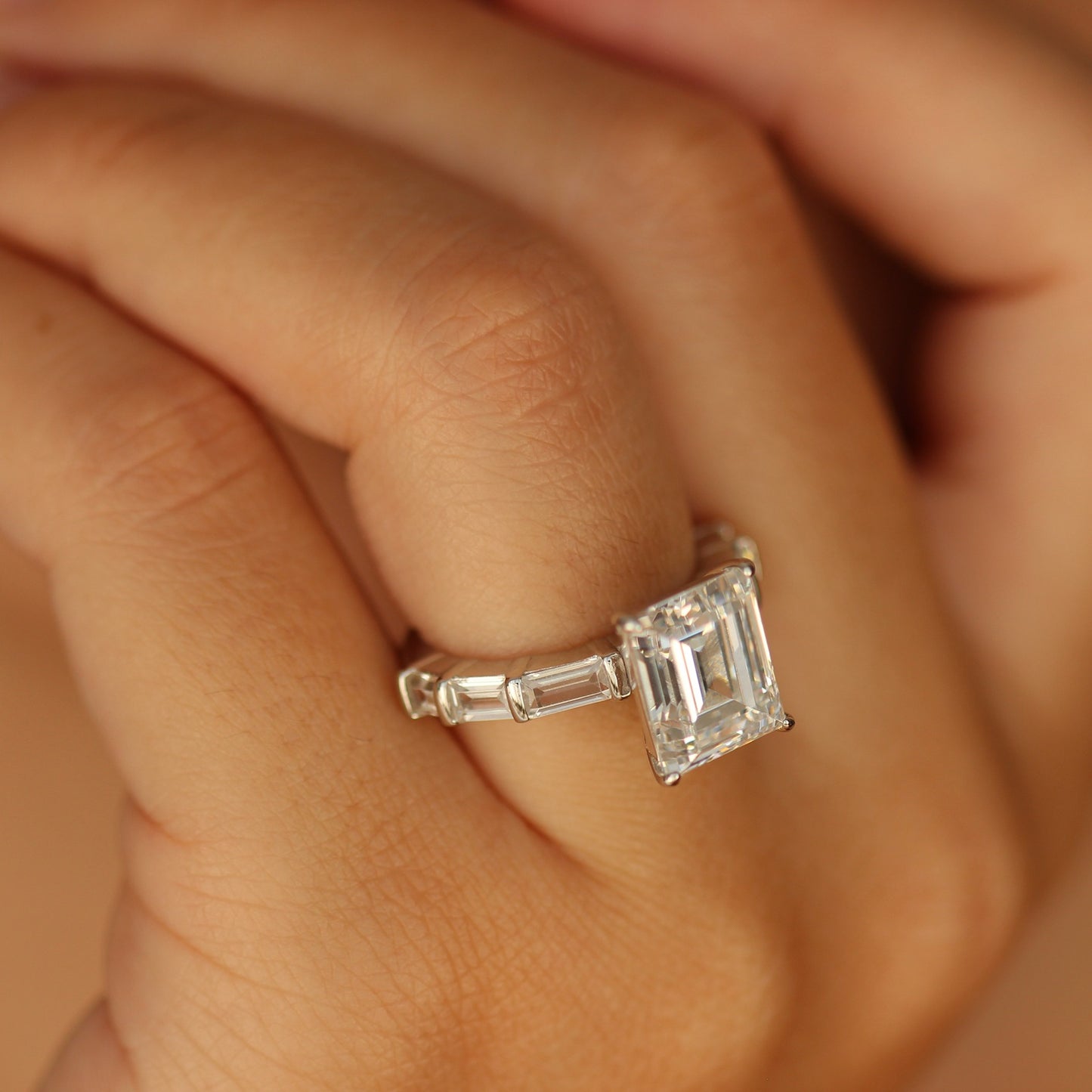 Emerald cut cubic zirconia ring on hand