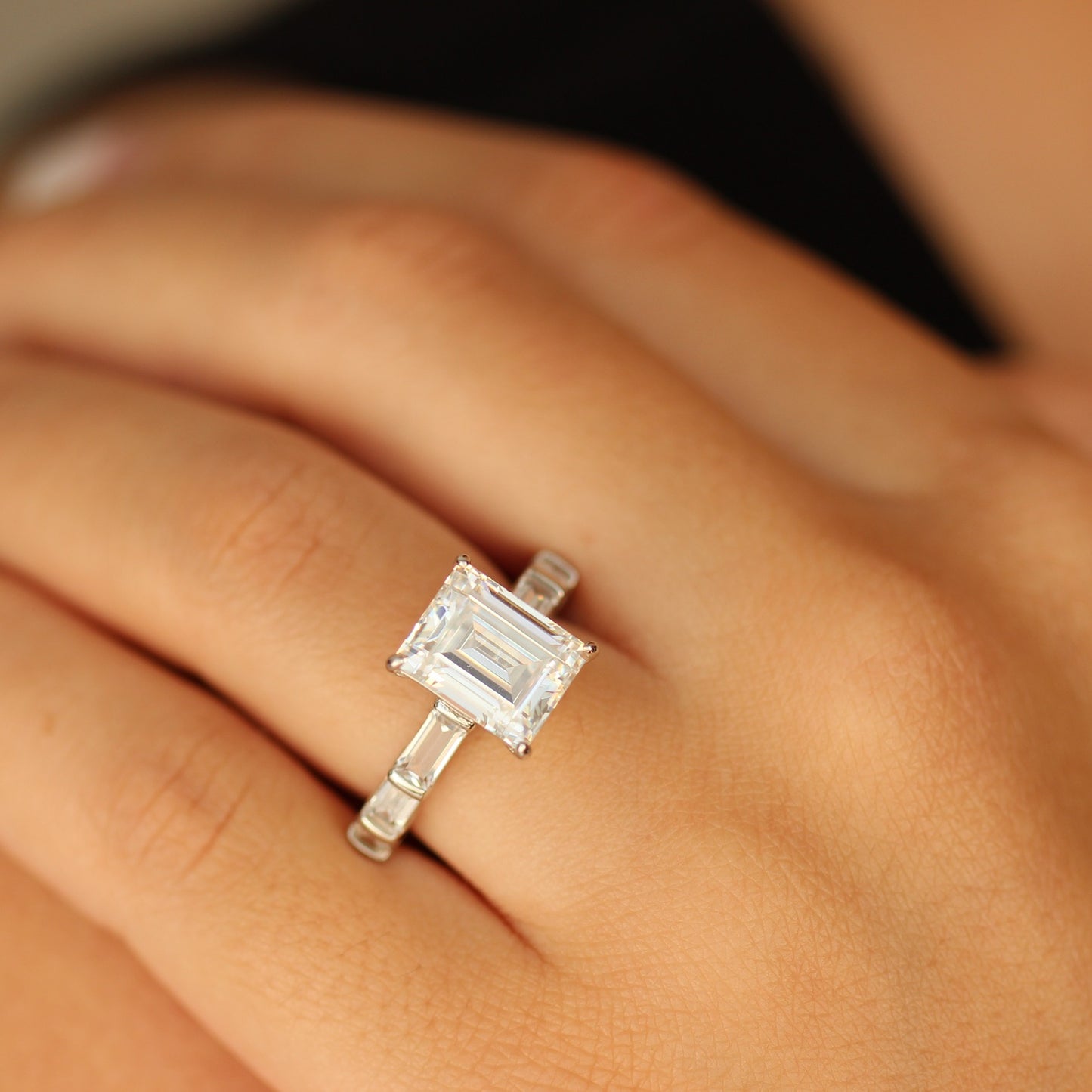 Emerald cut cubic zirconia ring on hand
