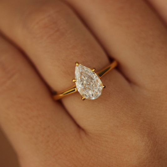 Gold pear ring on hand