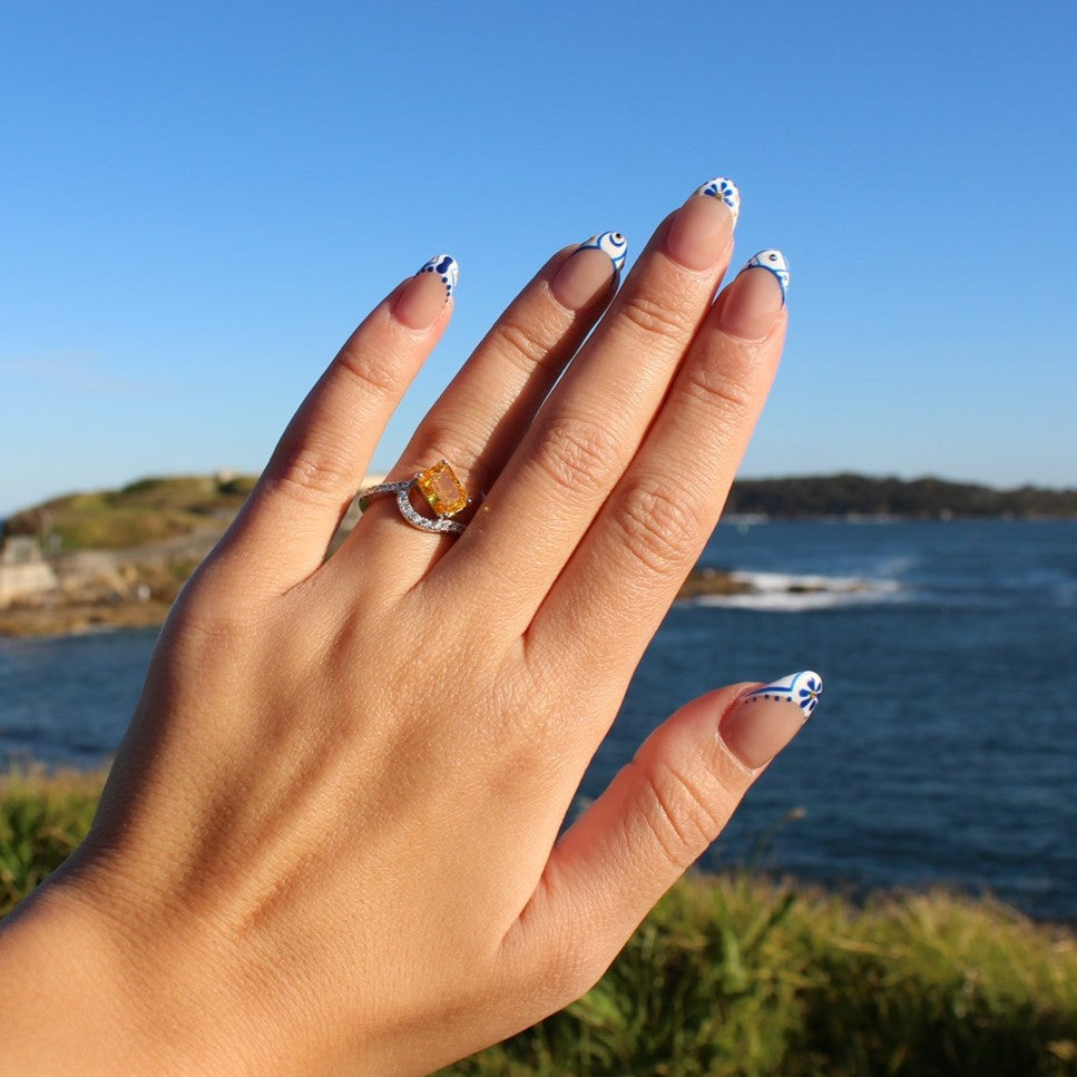 Yellow stone ring on hand at La Perouse Beach, Sydney