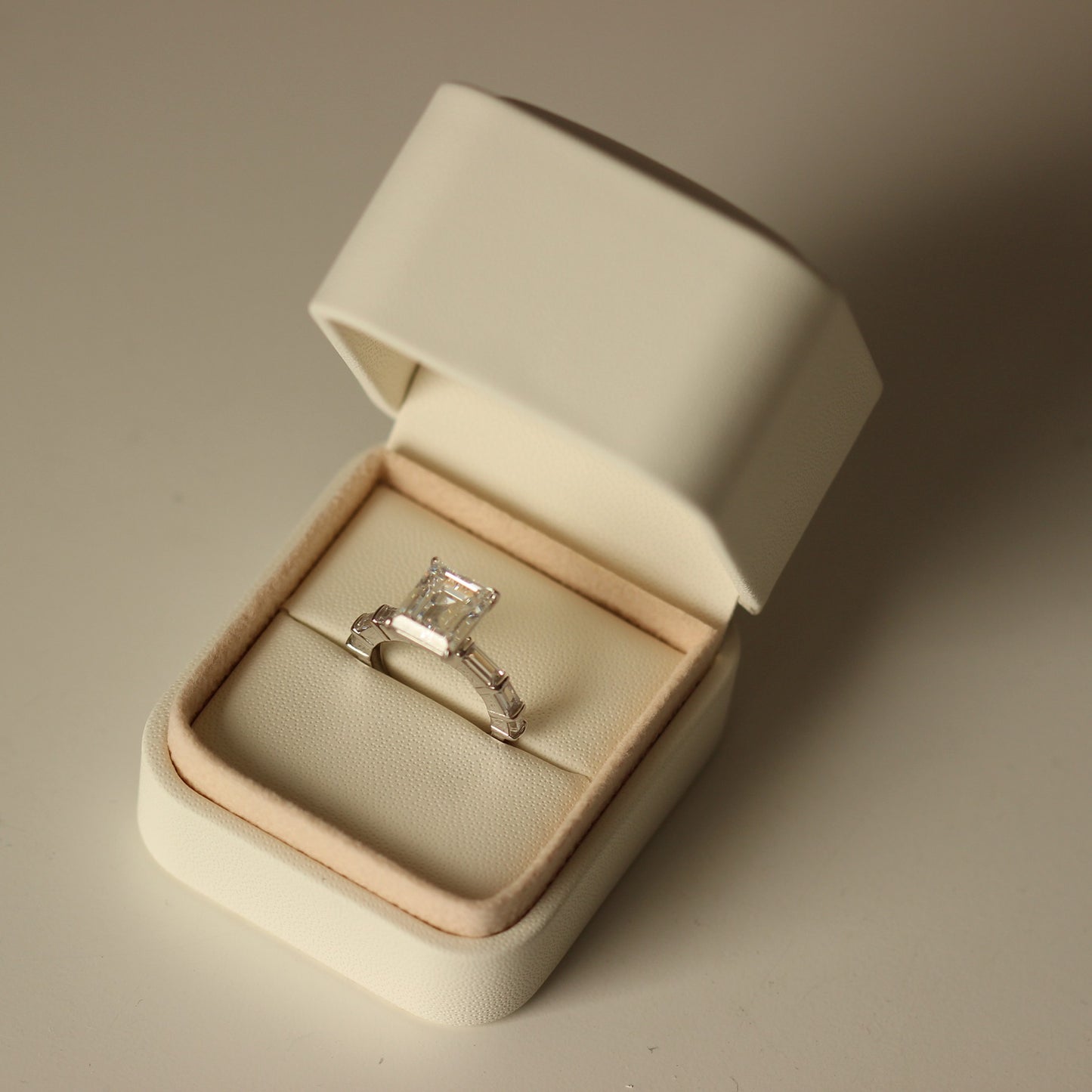 Proposal ring box with emerald ring inside