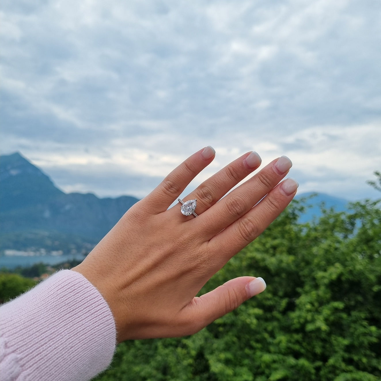 Pear cut ring on hand in Lake Como