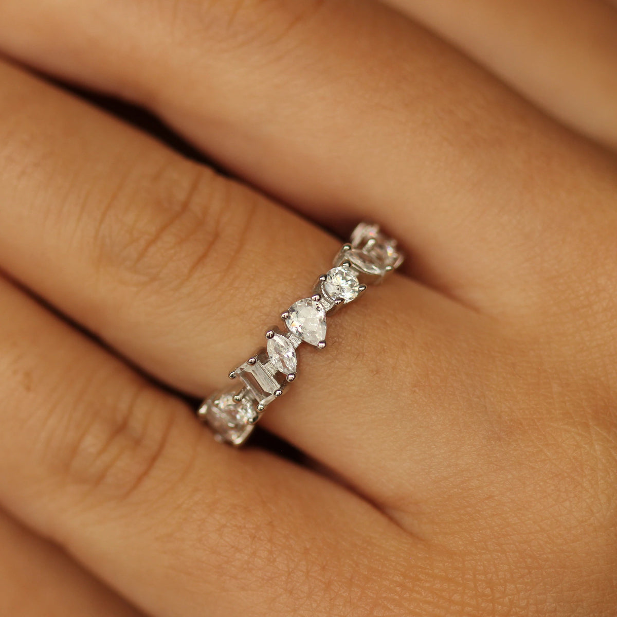 Silver statement ring on hand marquise, round and emerald cut stones