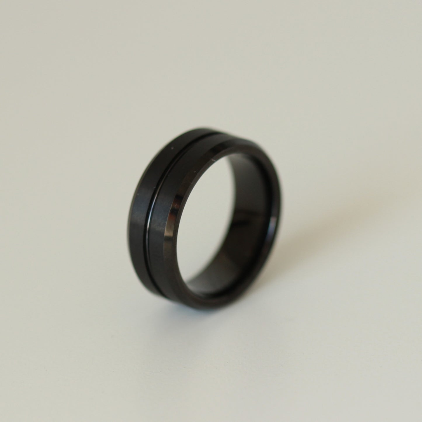 black men's ring on white background