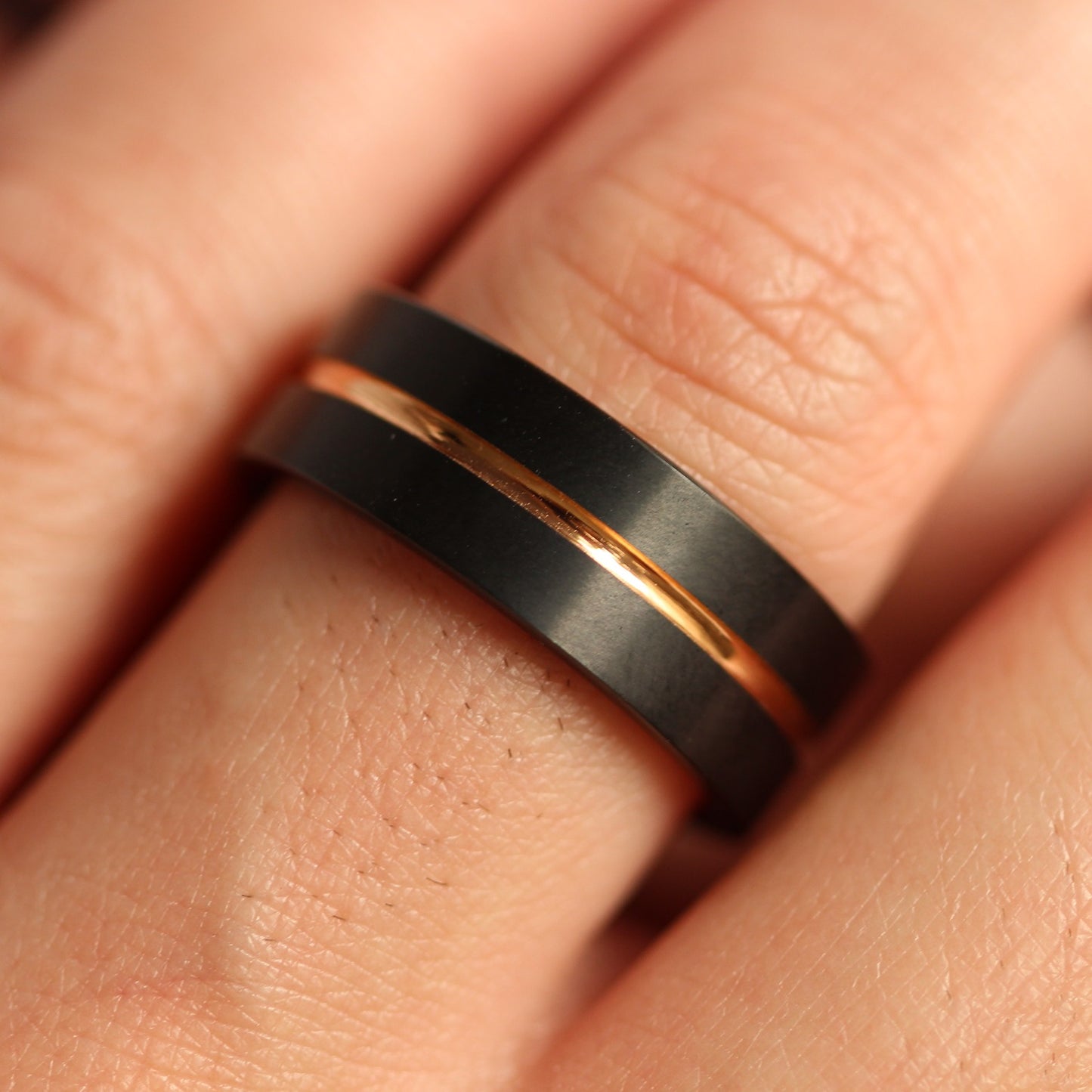 Rose gold black mens ring on
hand