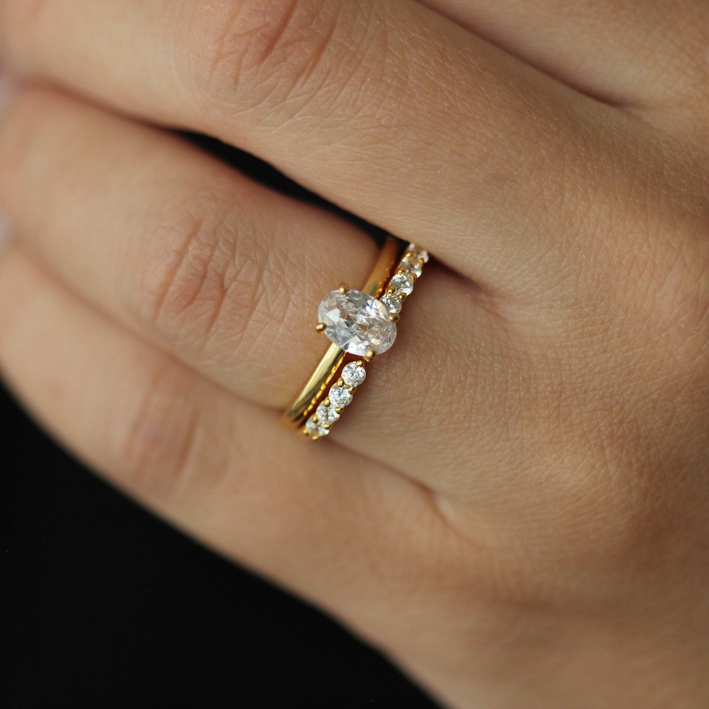 18k gold open wedding band with oval ring on hand