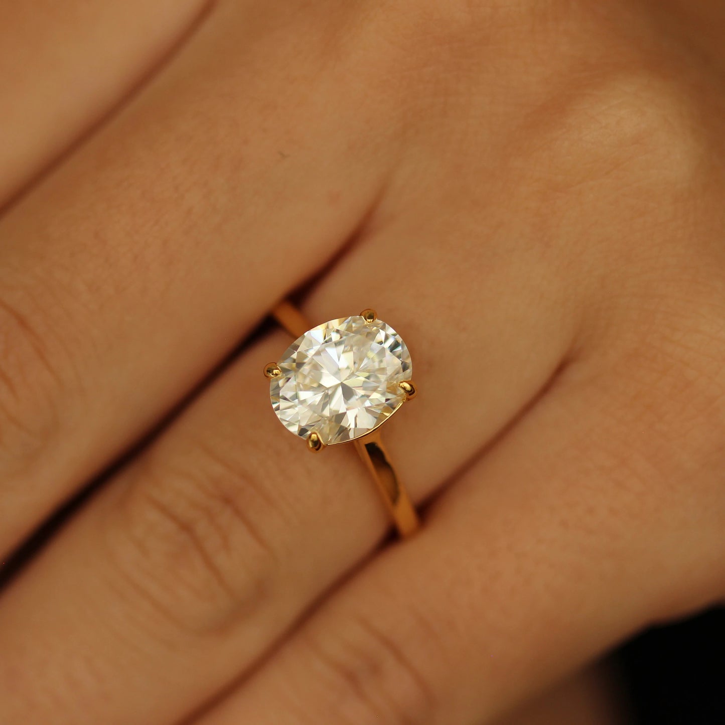 3 carat oval ring with gold band on hand
