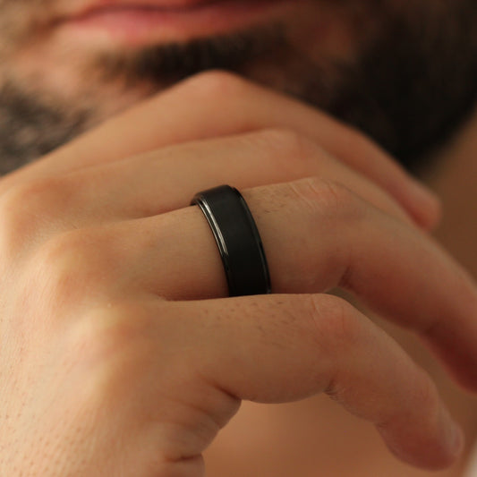 Male model chin pose wearing Black Men’s Ring 8mm with stepped edge