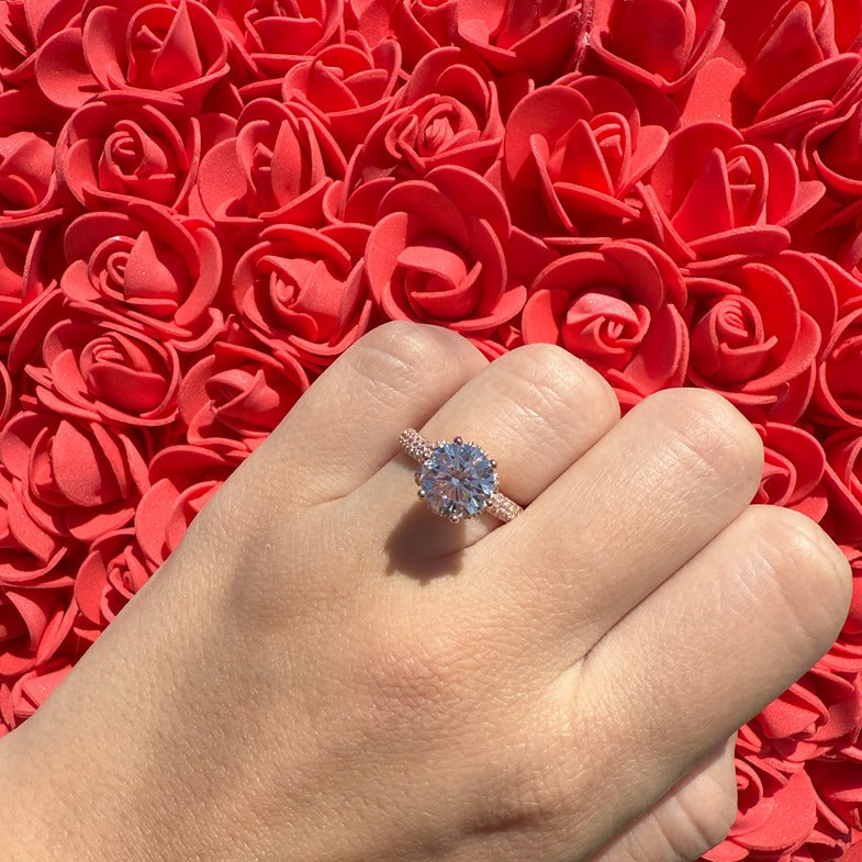 rose gold ring with round stone centre with cubic zirconia stones on band