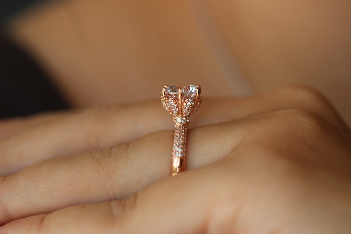 rose gold ring with round stone centre with cubic zirconia stones on band