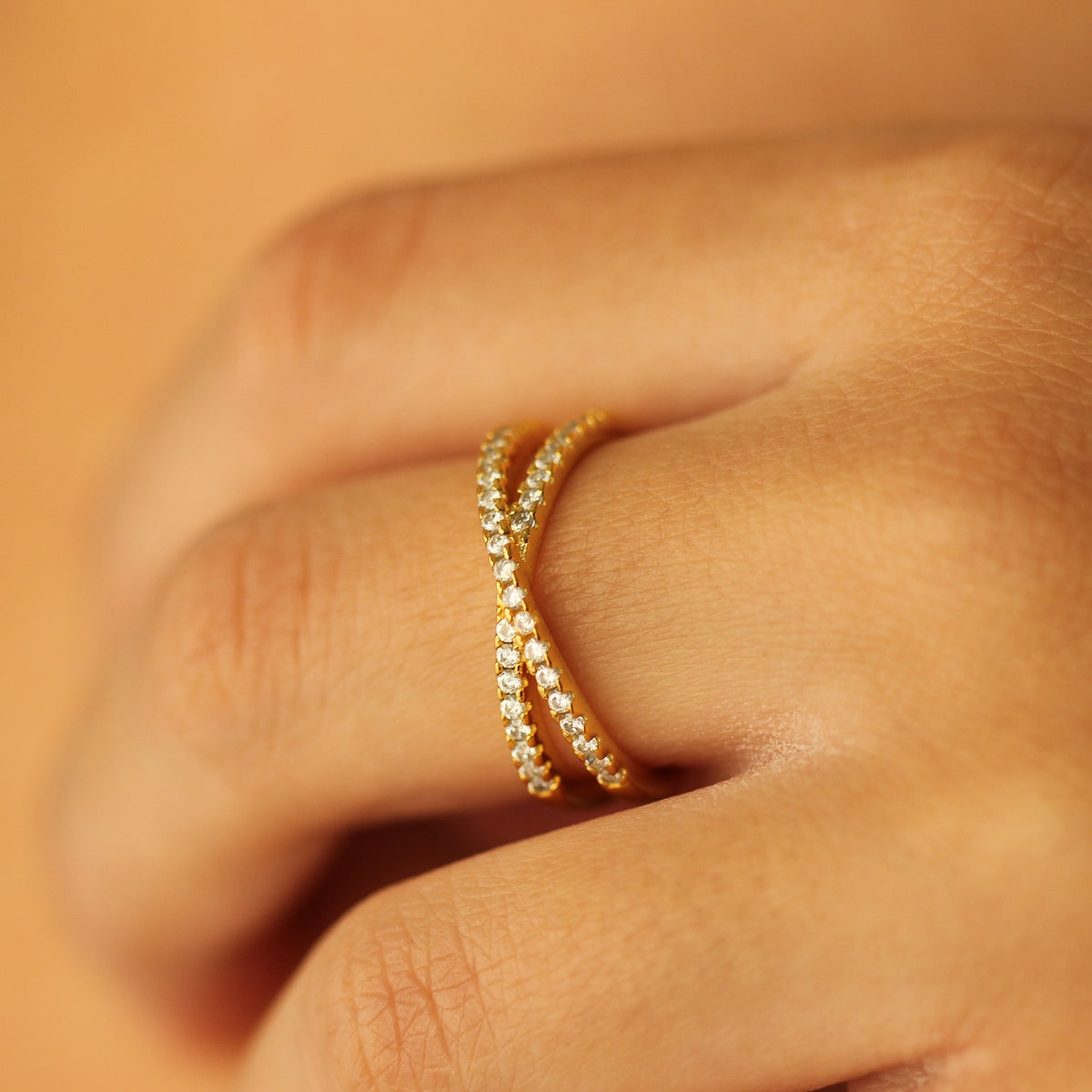 Criss cross gold ring on hand