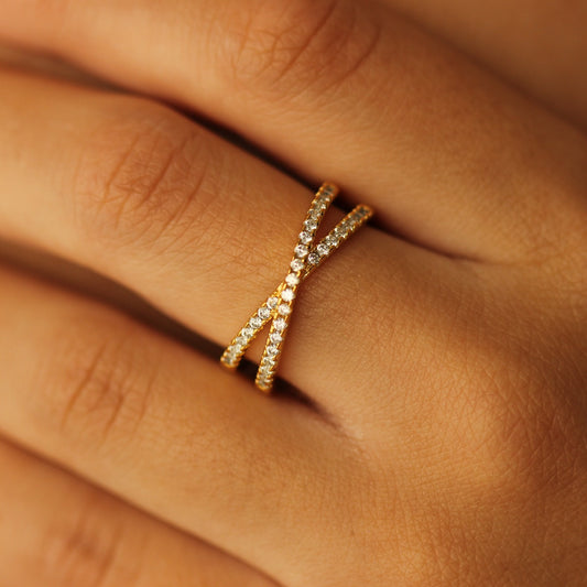 Criss cross gold ring on hand