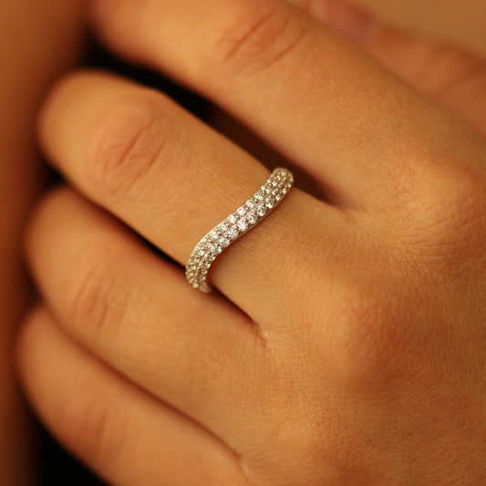 Silver curved pave ring on hand