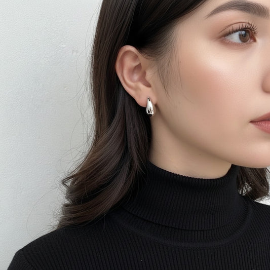 silver blob earrings on a model