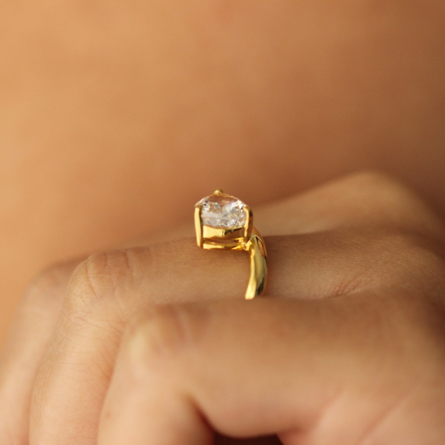 east west facing curved pear ring in gold