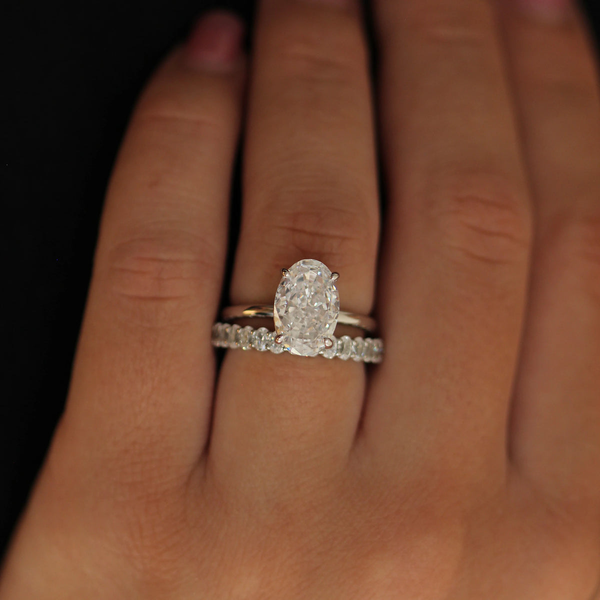 Silver oval ring with elongated cubic zirconia stone paired with eternity band