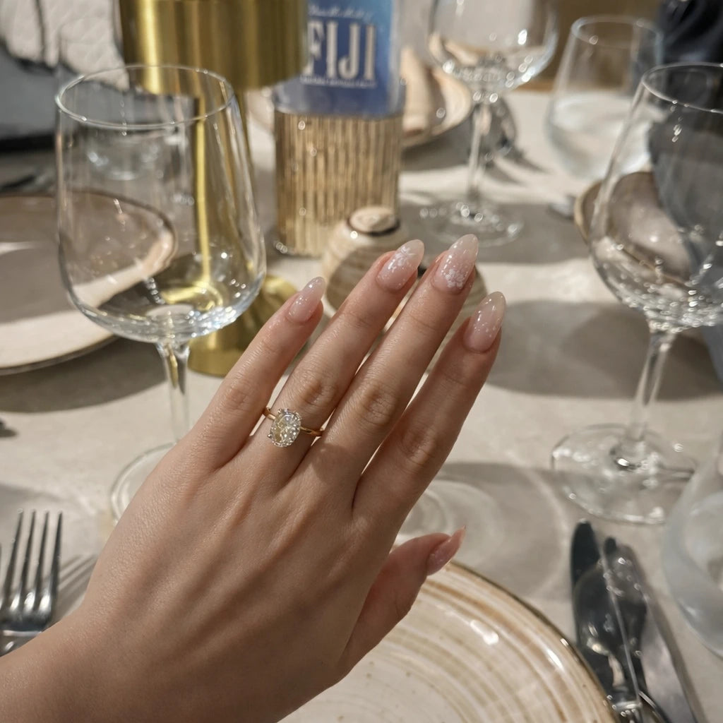 Woman wearing 3.5ct oval ring on hand at dinner table