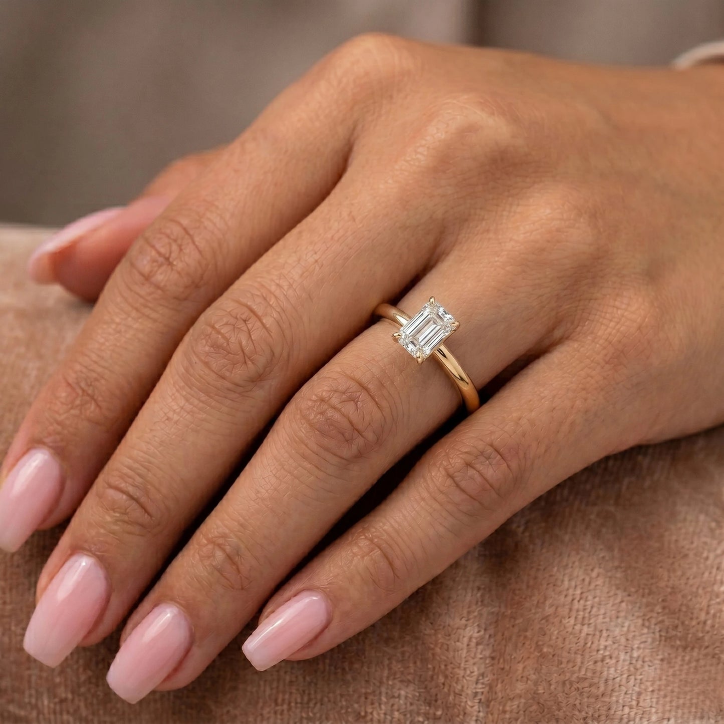 emerald cut lab grown diamond engagement ring on model hand