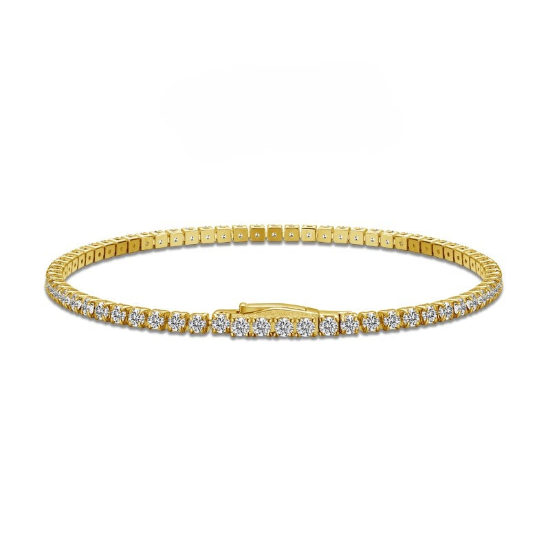 gold tennis bracelet 2.5mm with cz stones side on plaine white background
