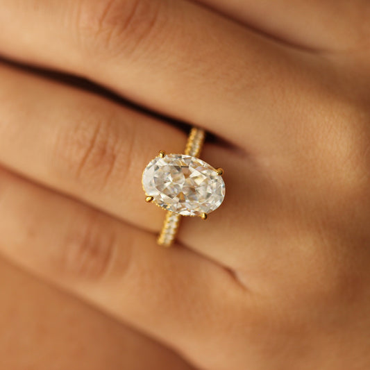 4 carat gold oval ring on pave band on hand