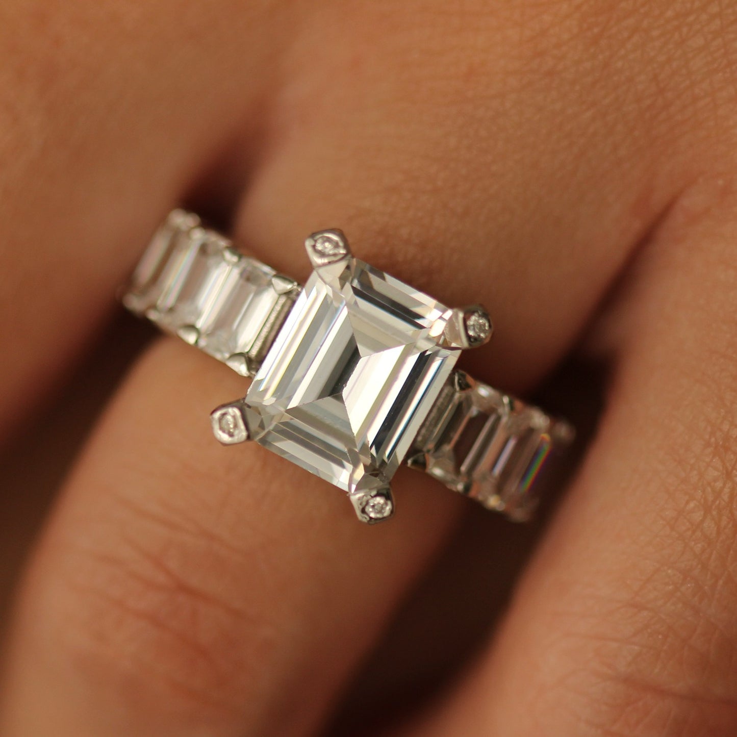 silver emerald ring with baguette side stones on hand