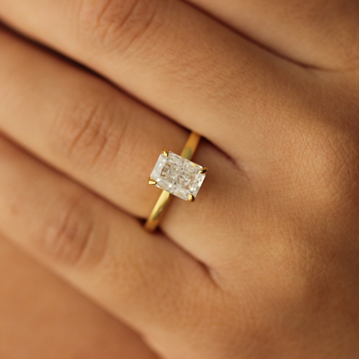 plain gold ring with 2 carat rectangle cubic zirconia centre stone on hand