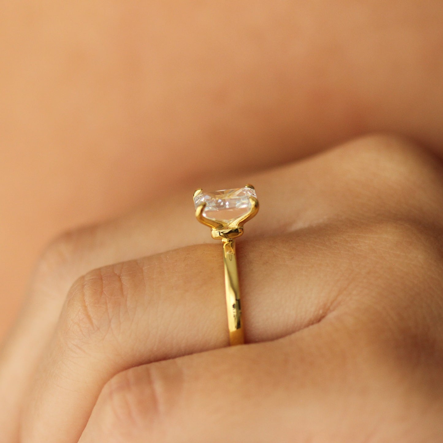 plain gold ring with 2 carat rectangle cubic zirconia centre stone on hand side profile