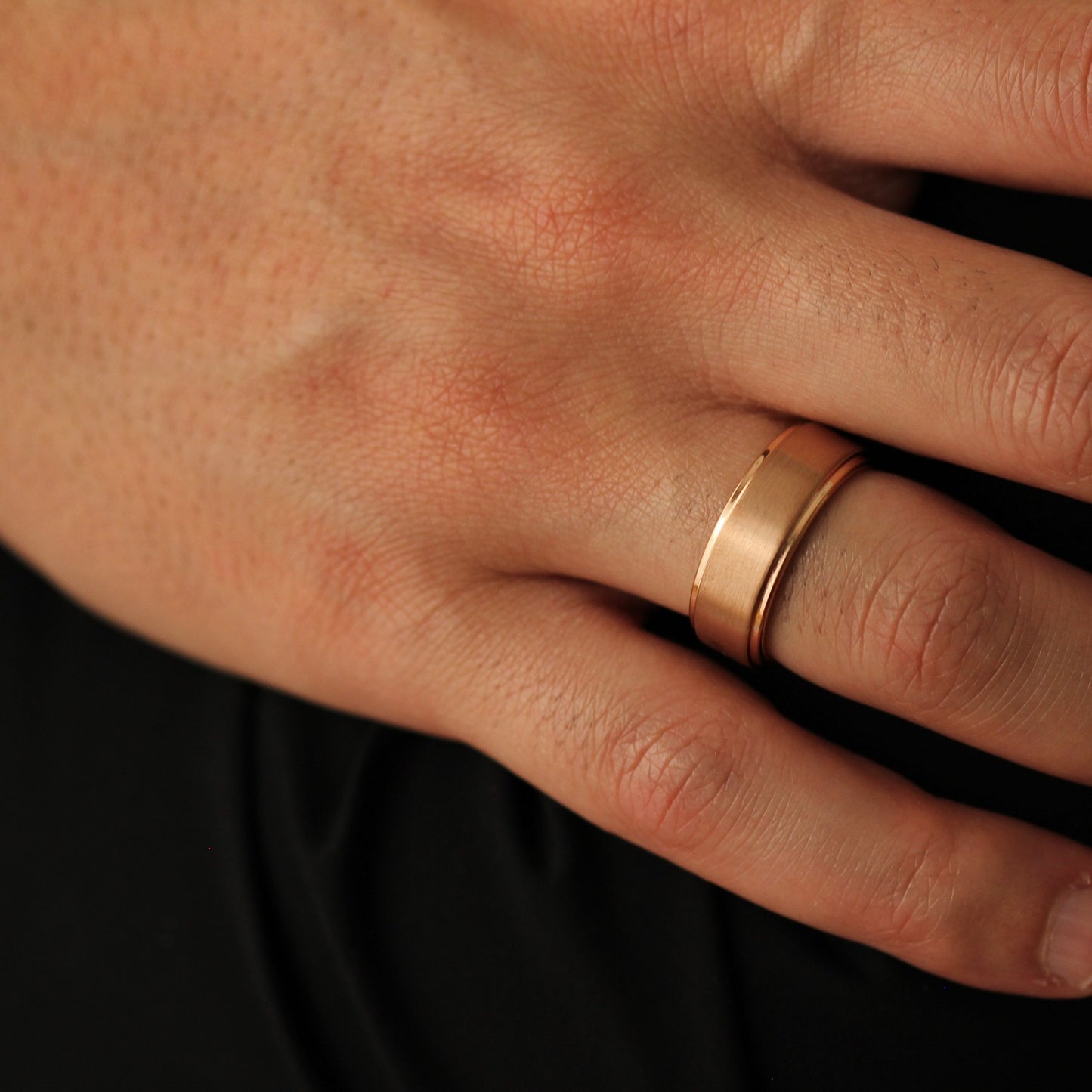 Men’s rose gold wedding band with stepped edges